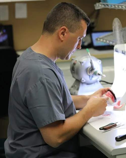 Dan Mihajlov working in the denture laboratory